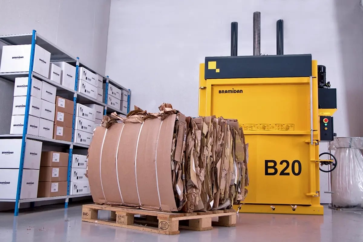 Stacked cardboard bales tied with wire on pallet ready for recycling and transport