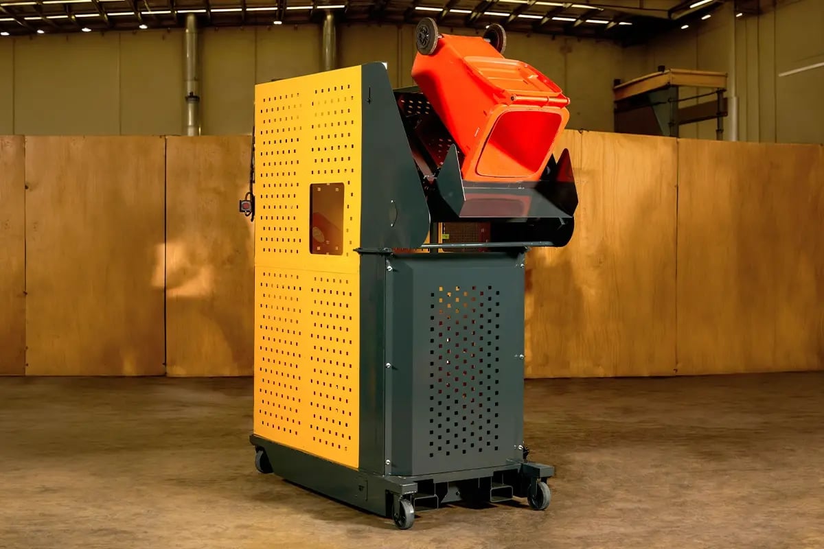 Wastech Slimline Bin Lifter with wheelie bin fully inverted at tip height inside the enclosed cage