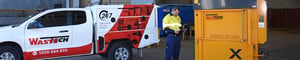 Wastech service technician and van attending an on-site waste equipment repair in Australia
